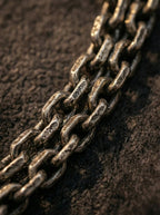 Close-up texture of heavy rustic metal chain links on Tibetan necklace