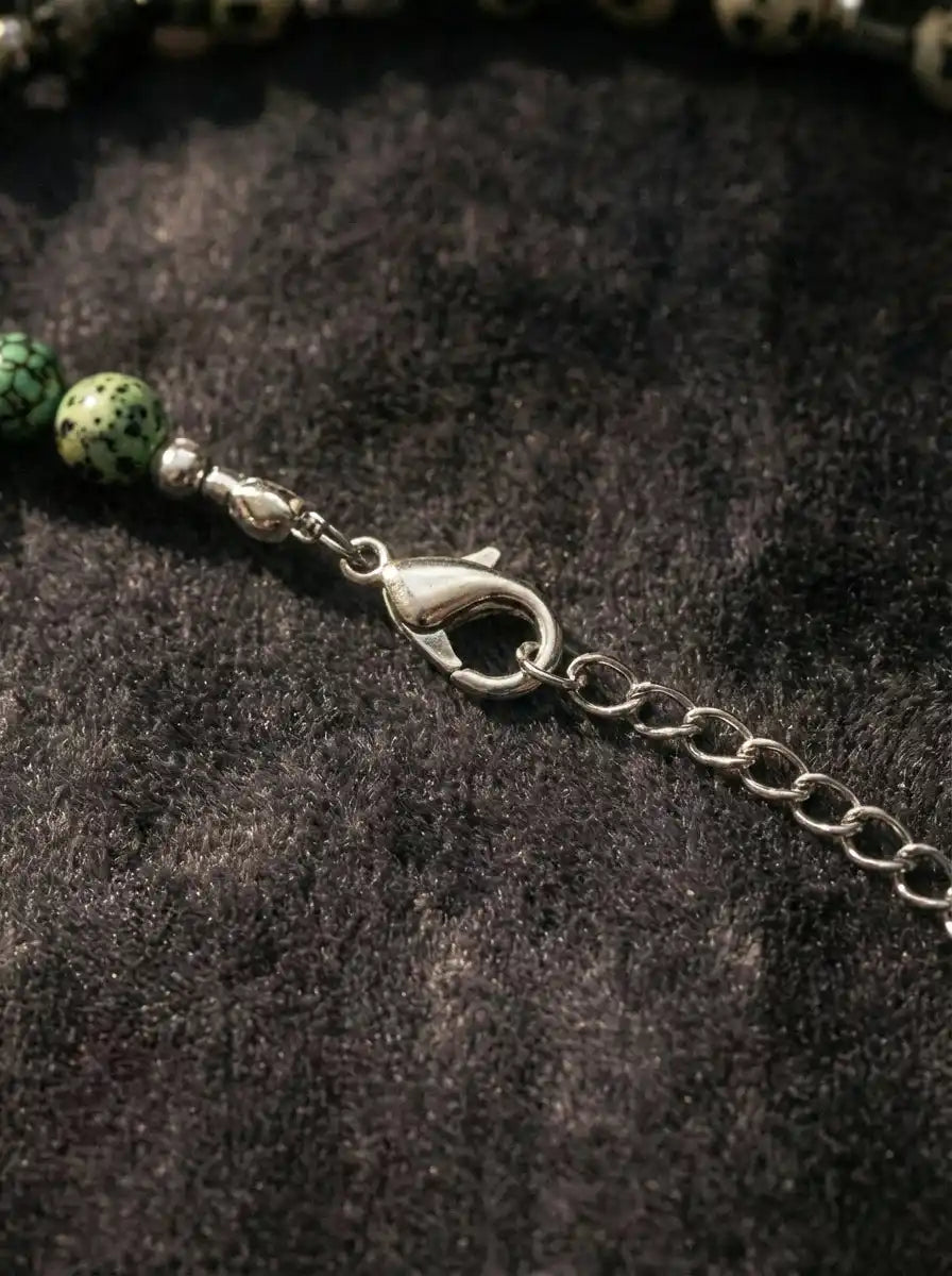 Close-up of metallic lobster claw clasp on Tibetan gemstone necklace
