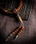 Detail shot of hand-knotted cotton cord tassels and aged yak bone counter beads