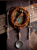 Full lay flat view of 108 yak bone bead necklace with Vajra counters, Dzi bead, and Bagua charm